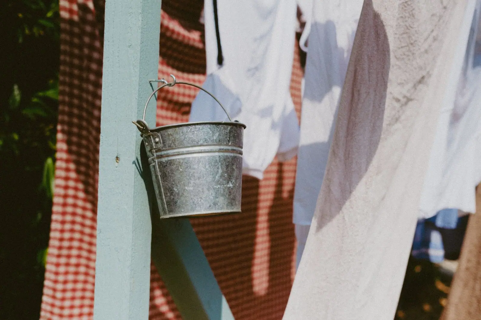 A galvanised metal bucket hanging outdoors