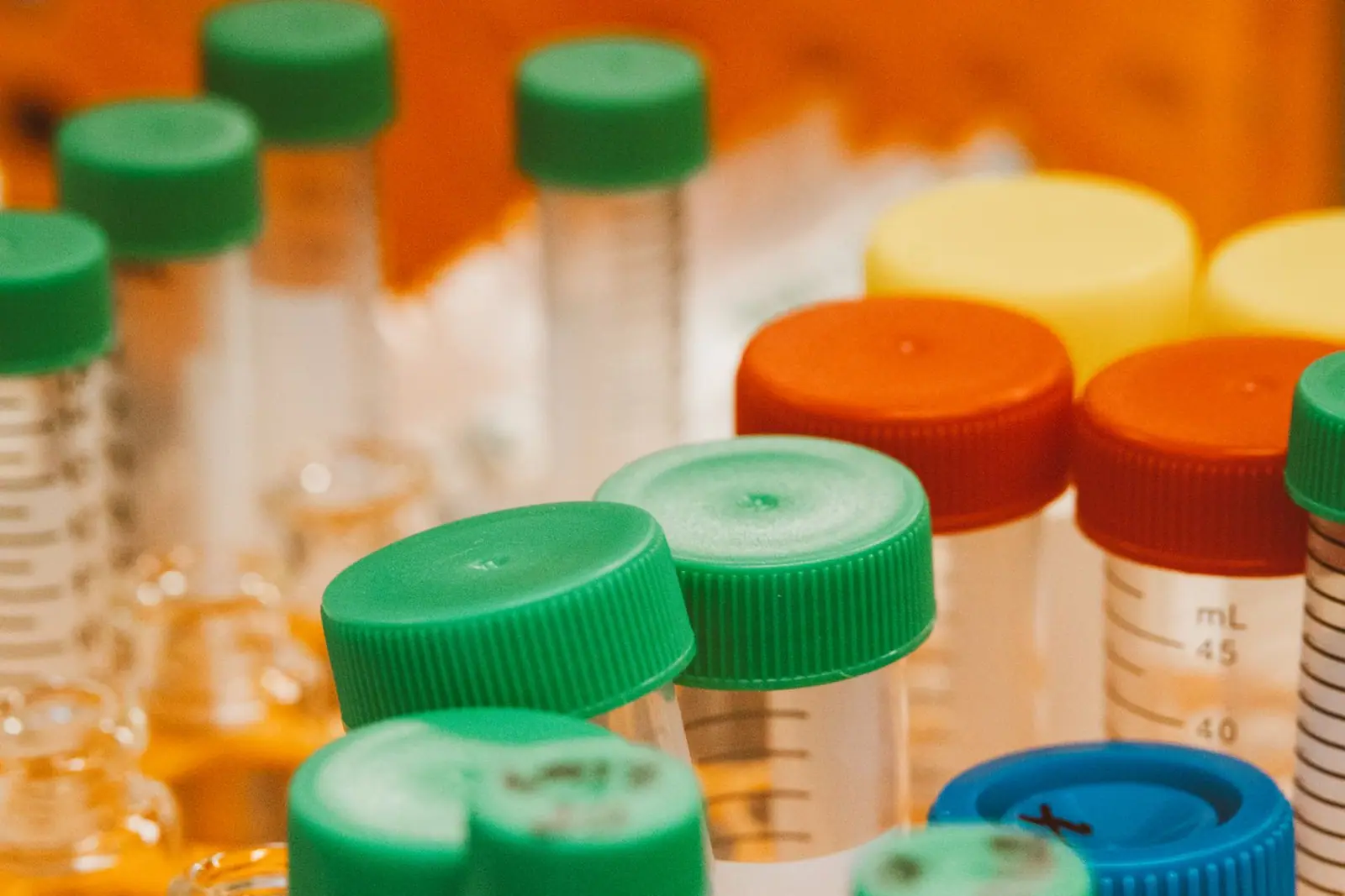 Plastic chemical bottles with coloured caps on a shelf