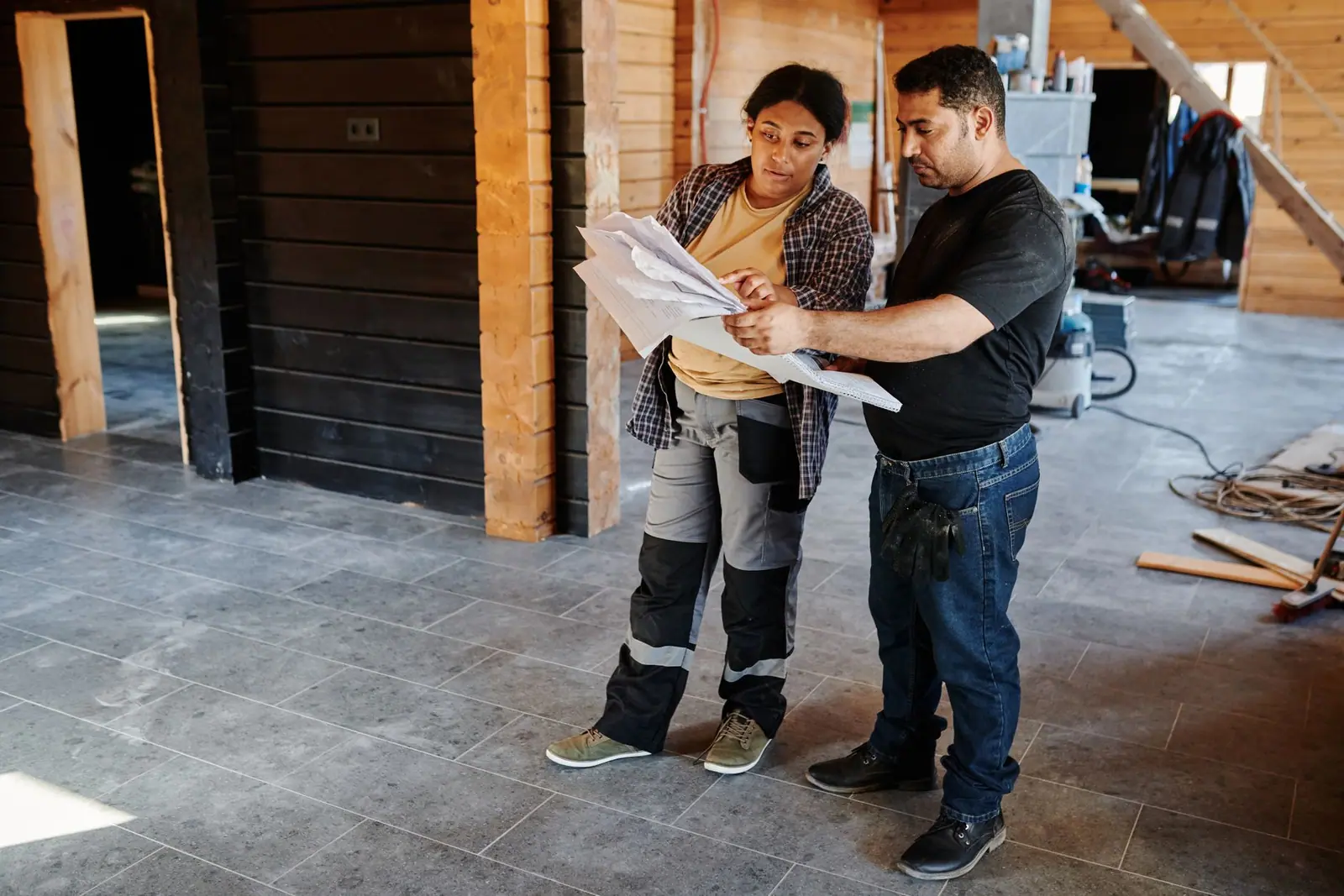 Two people going through paperwork on a building site