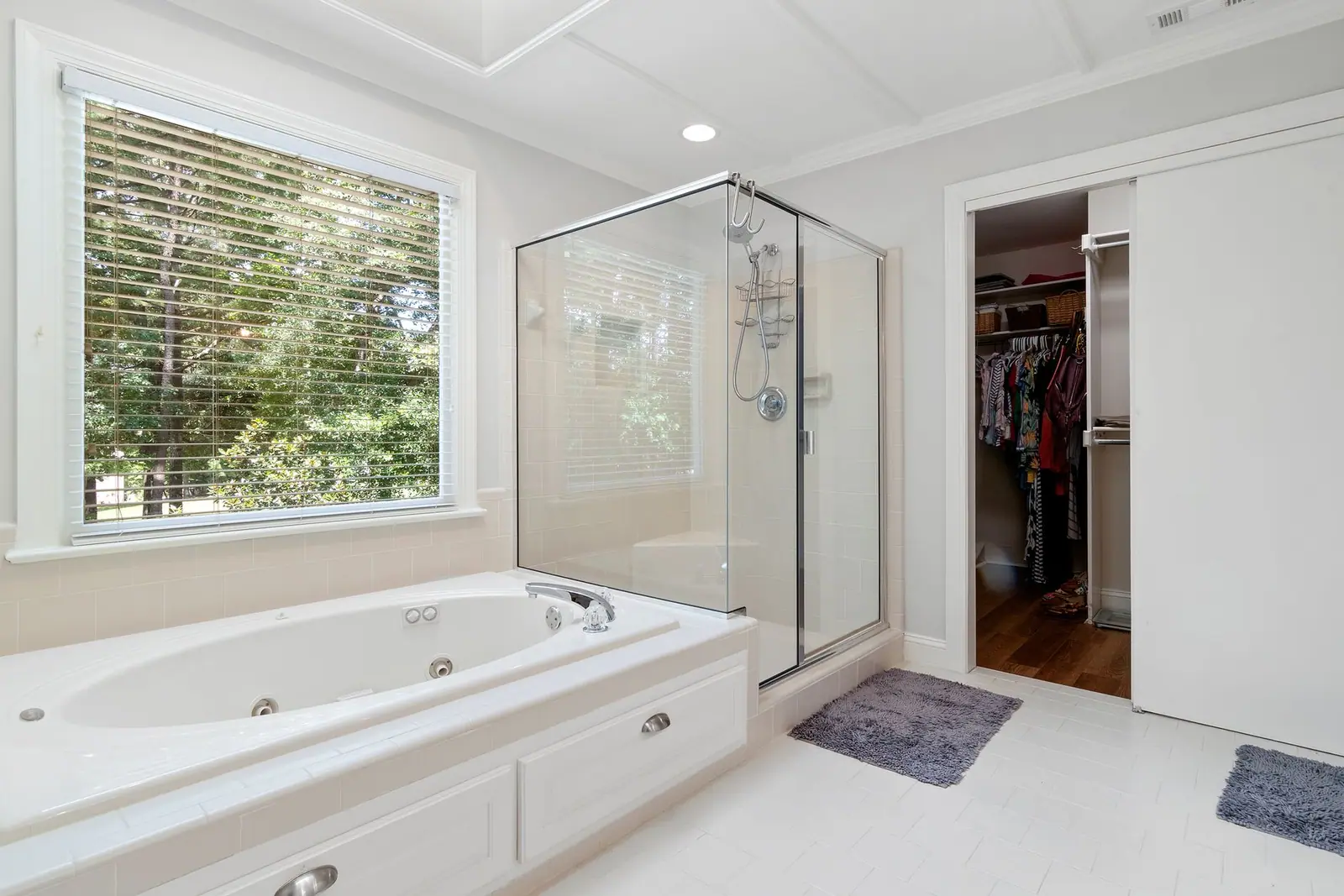 A small mat on a bathroom floor beside a bath