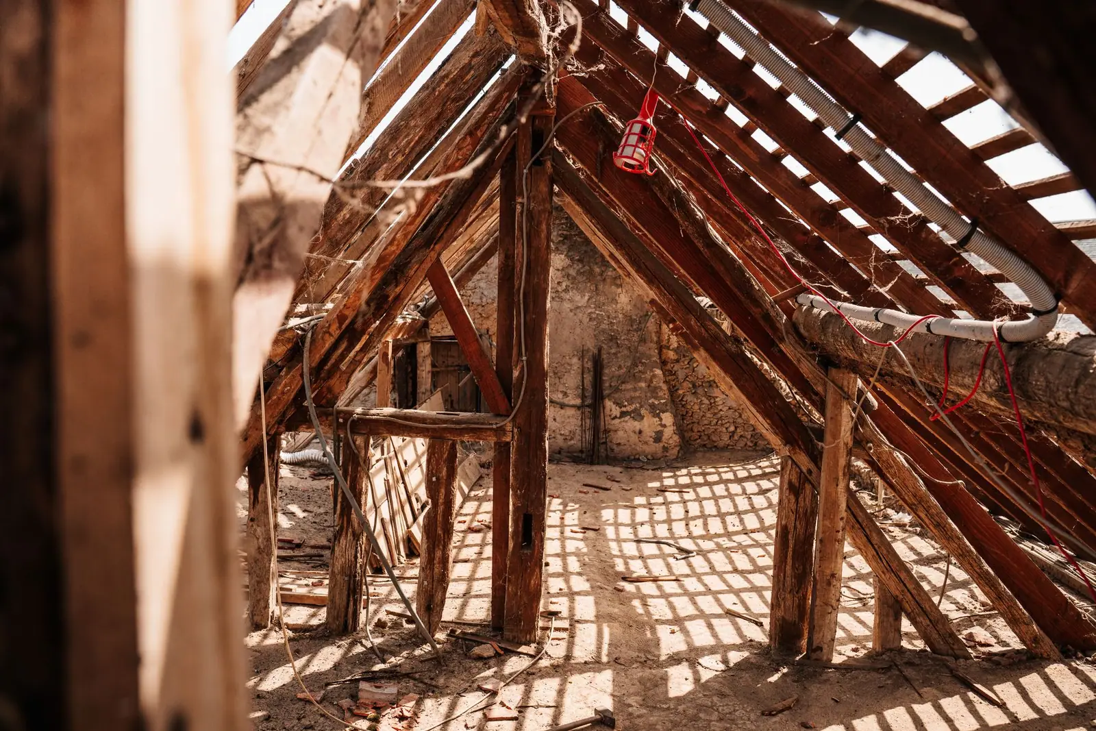 The inside of an attic with exposed roof timbers