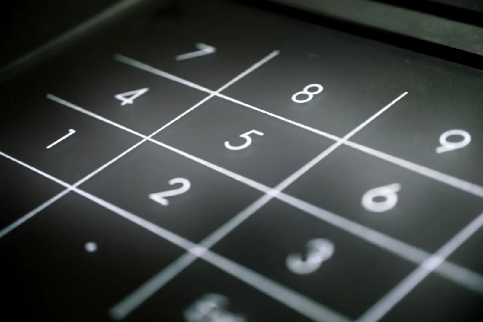A close view of a black keypad with white numbers