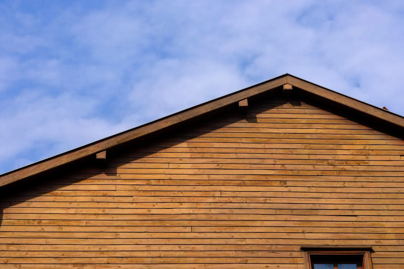 Wood cladding covering the gable and wall of a house