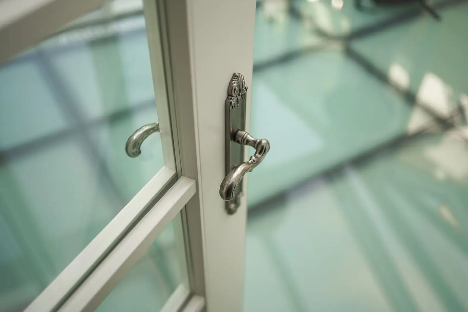 A close view of an ornate handle on a glazed door