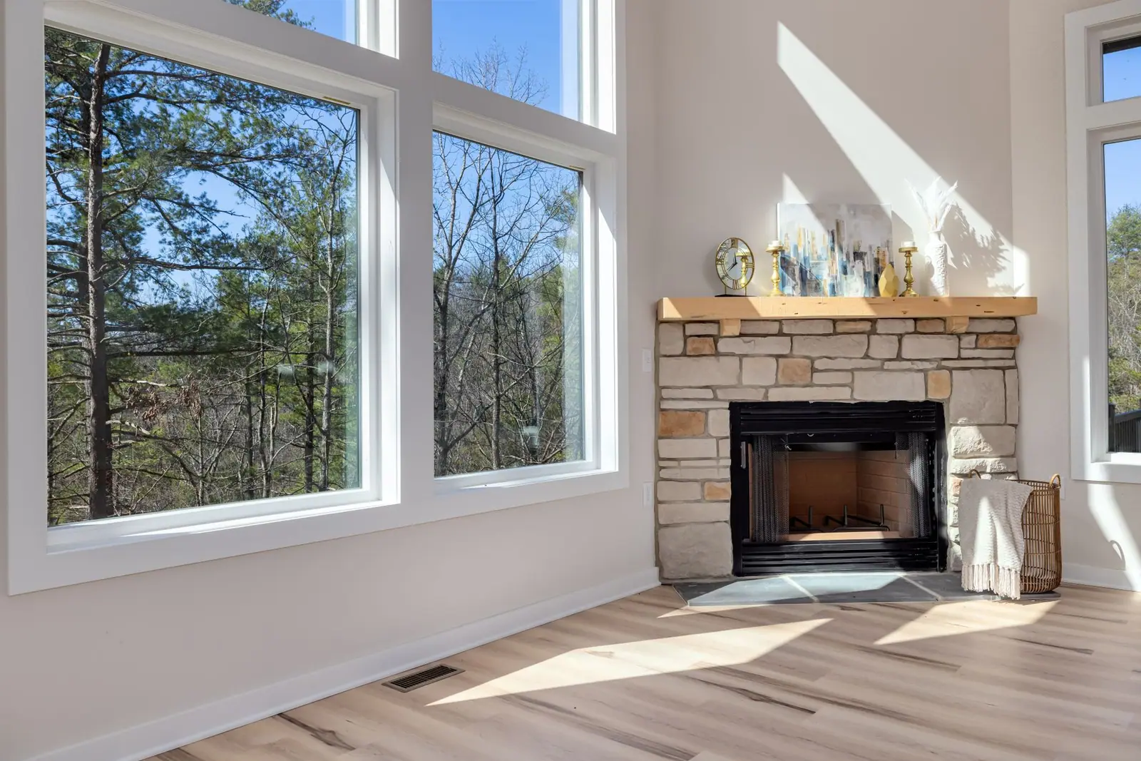 A bright room with large windows and a fireplace